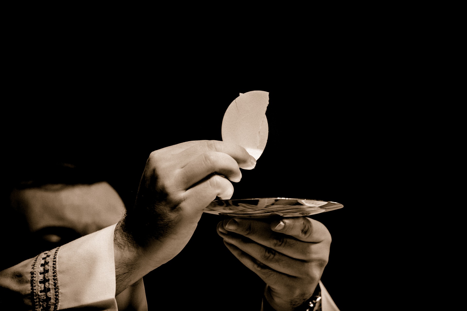 Eucharist in Priest's Hands