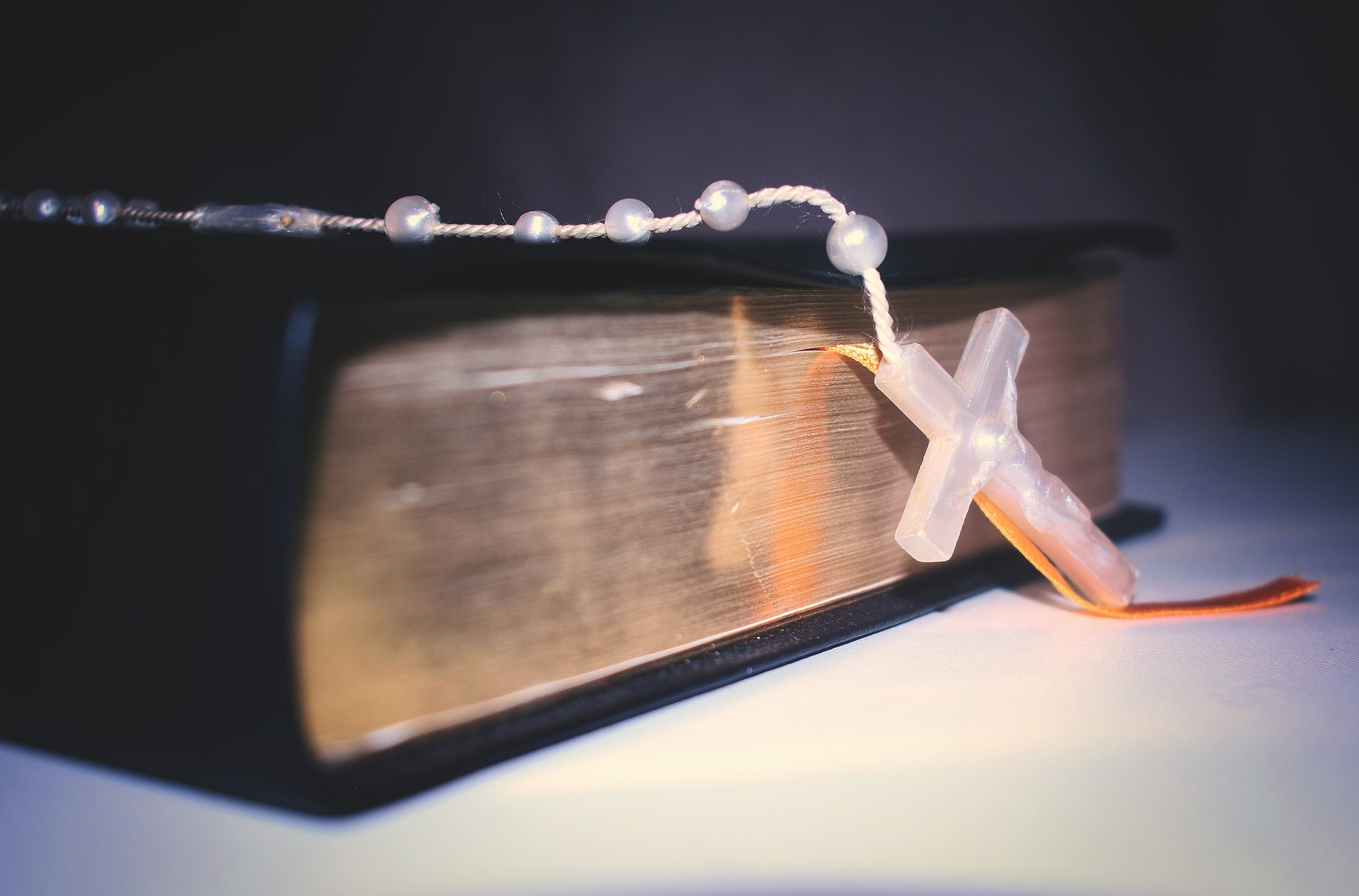 Holy Bible draped with Rosary